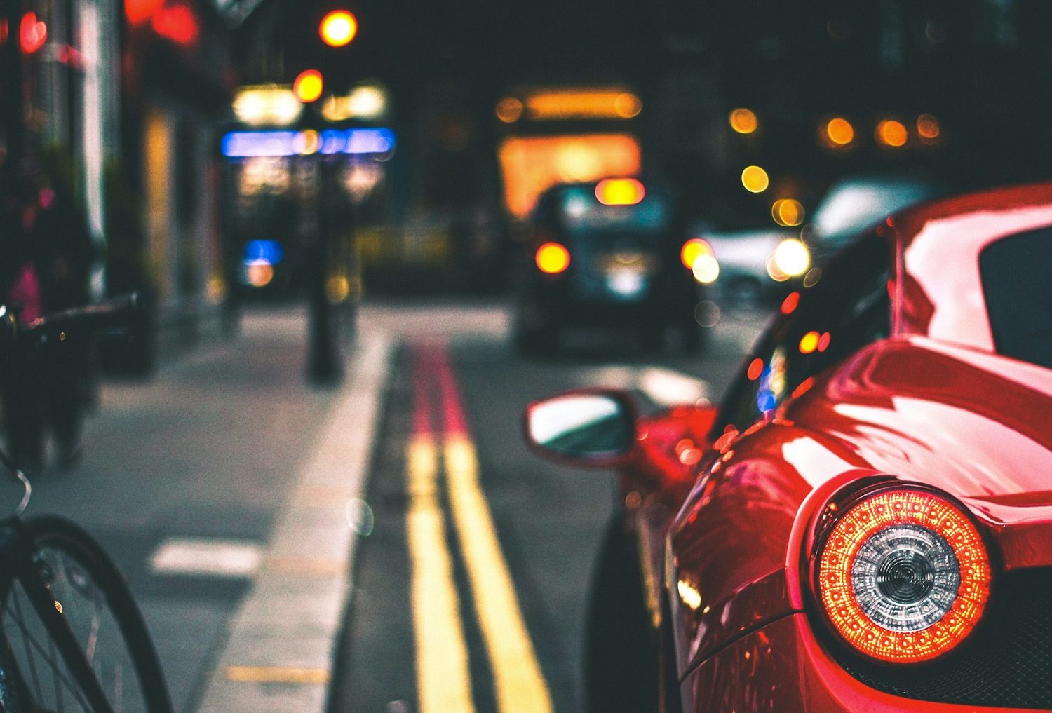 A driver's hands on the steering wheel at dusk